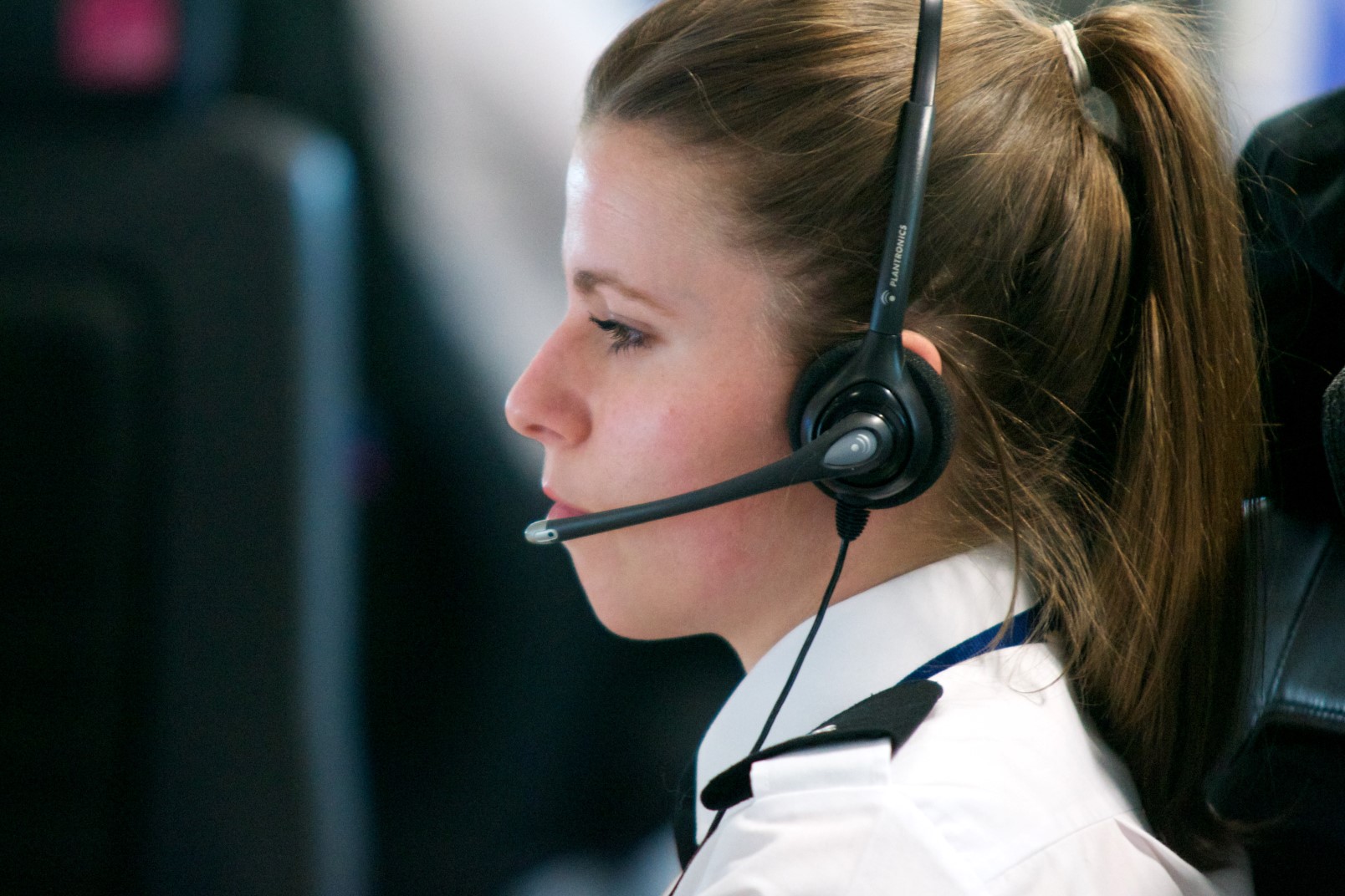 Side profile of a woman wearing a headset 